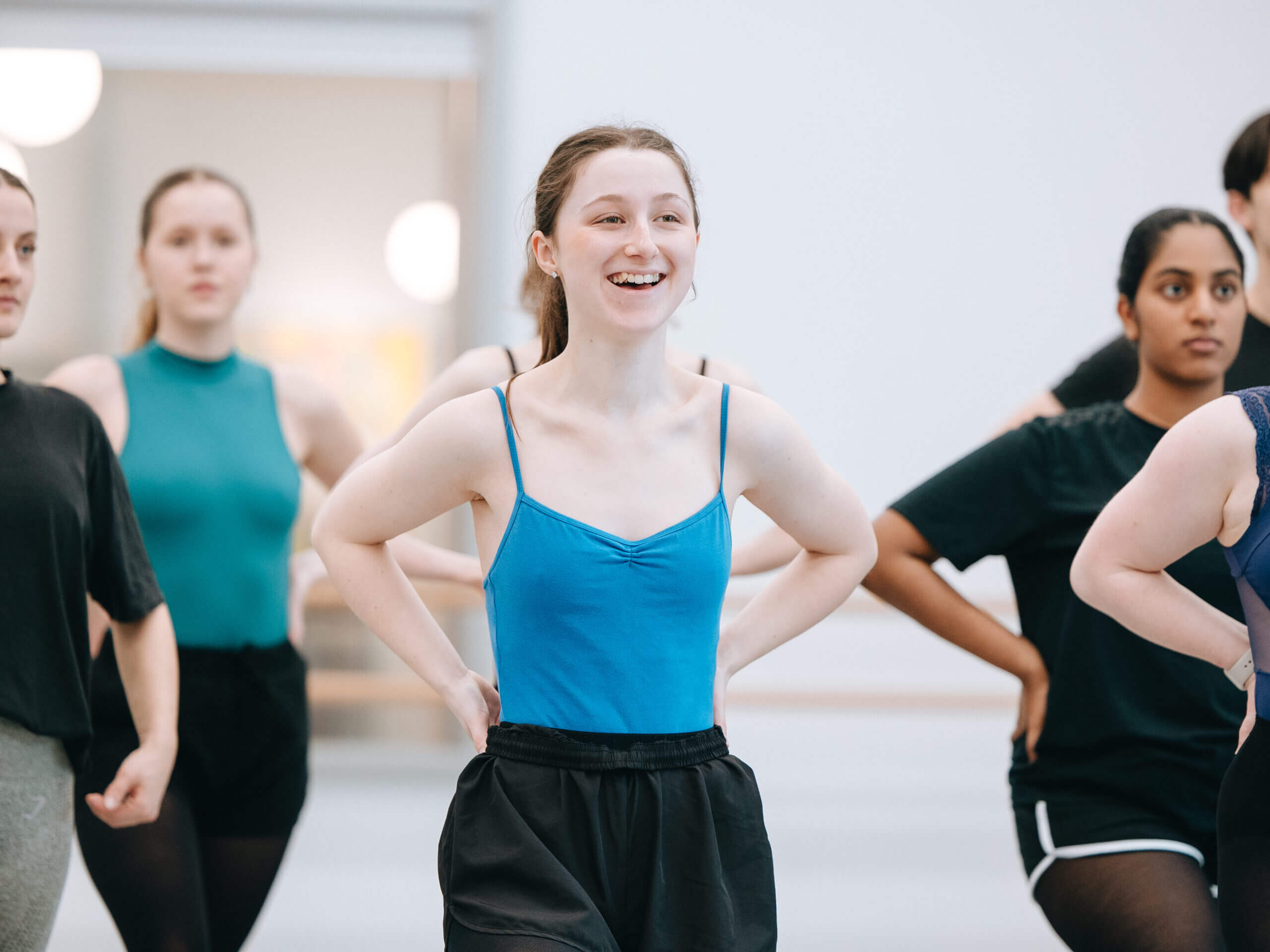a student smiling in a dance class at the RAD